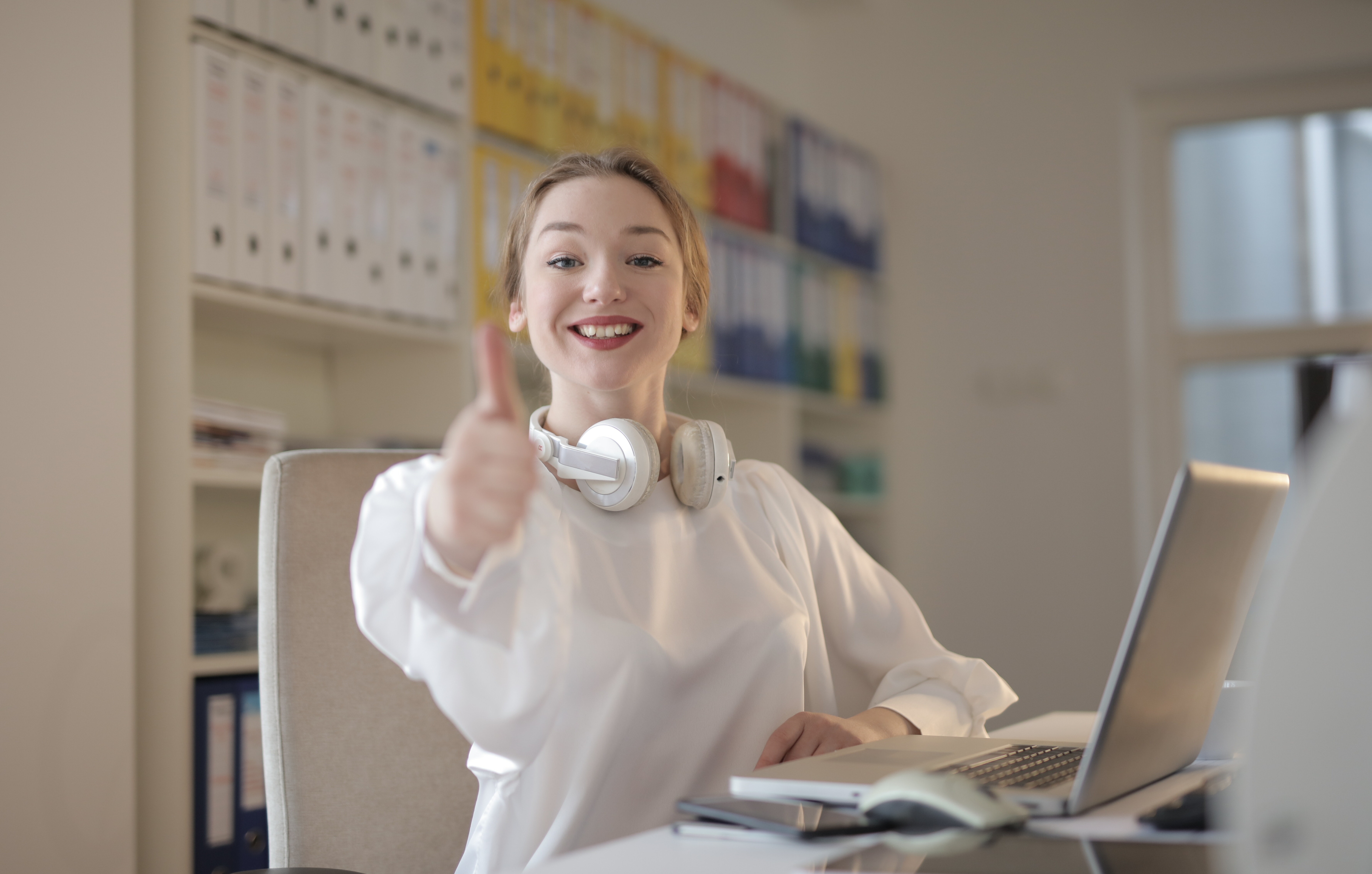girl is doing thumbs up while smiling