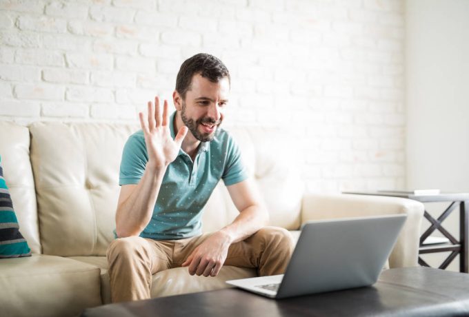 Young man video chatting through laptop