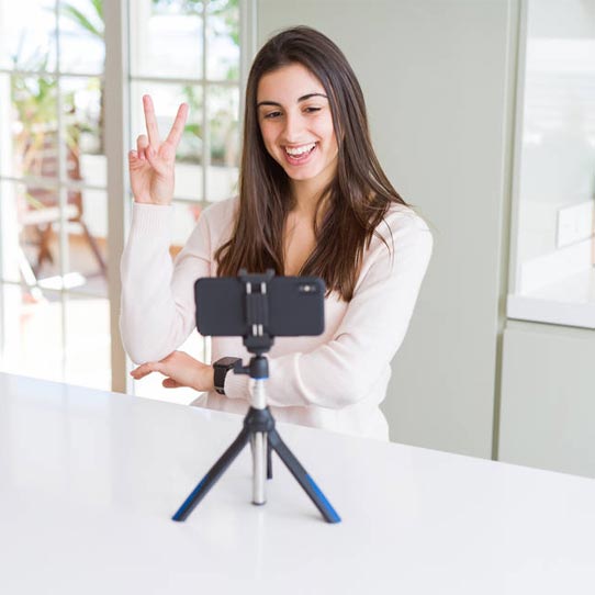 Young Girl is Creating a Video Using a Front Camera of Mobile Phone